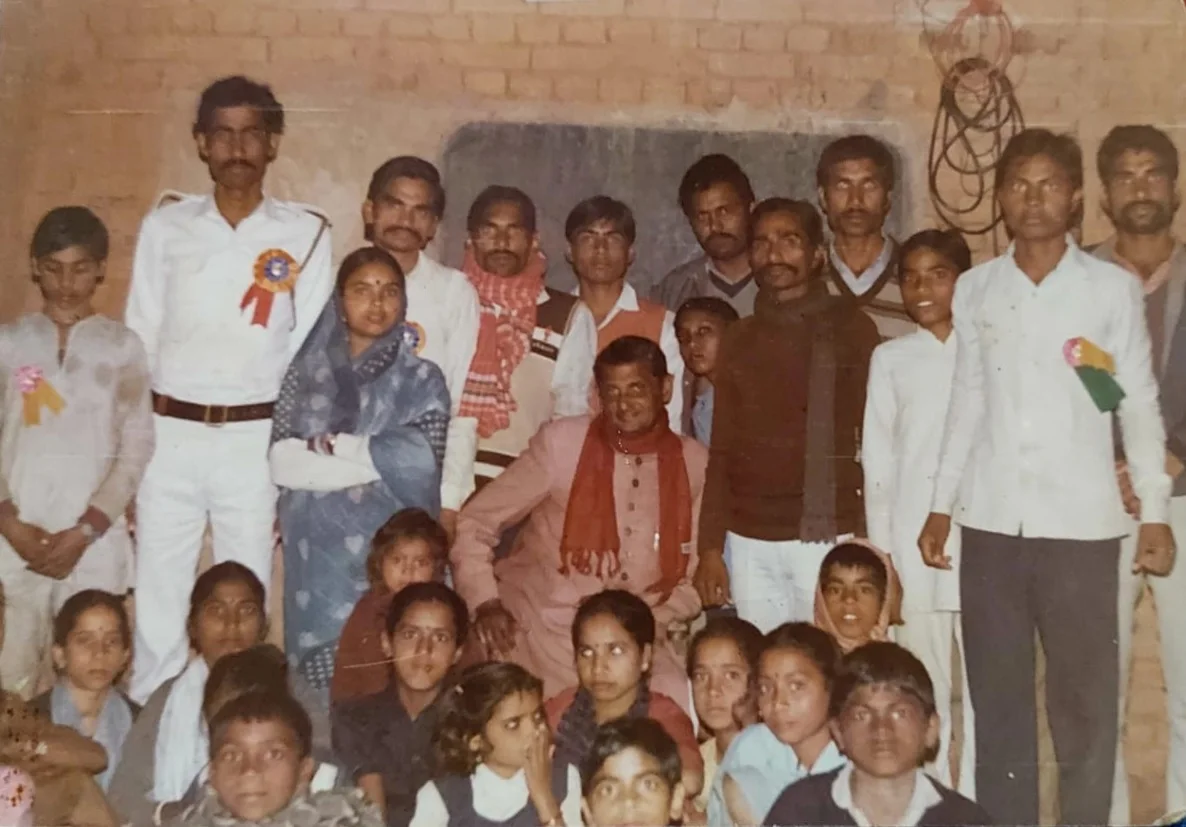 An archival photograph of community members and children