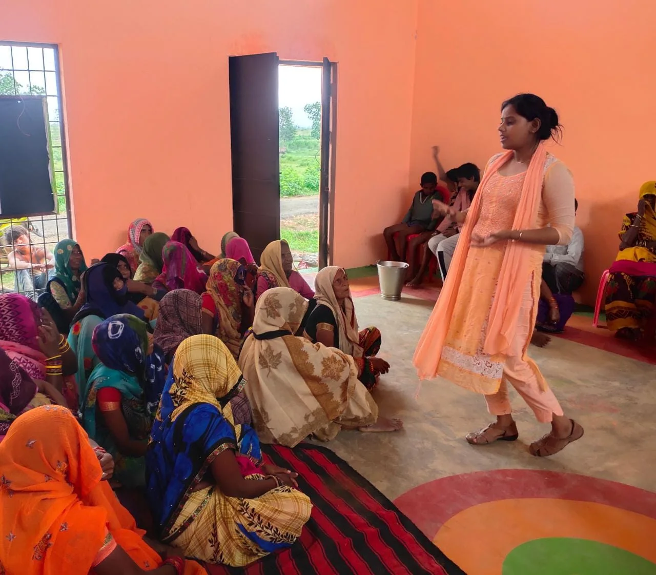 A community awareness session led by a woman in rural Uttar Pradesh